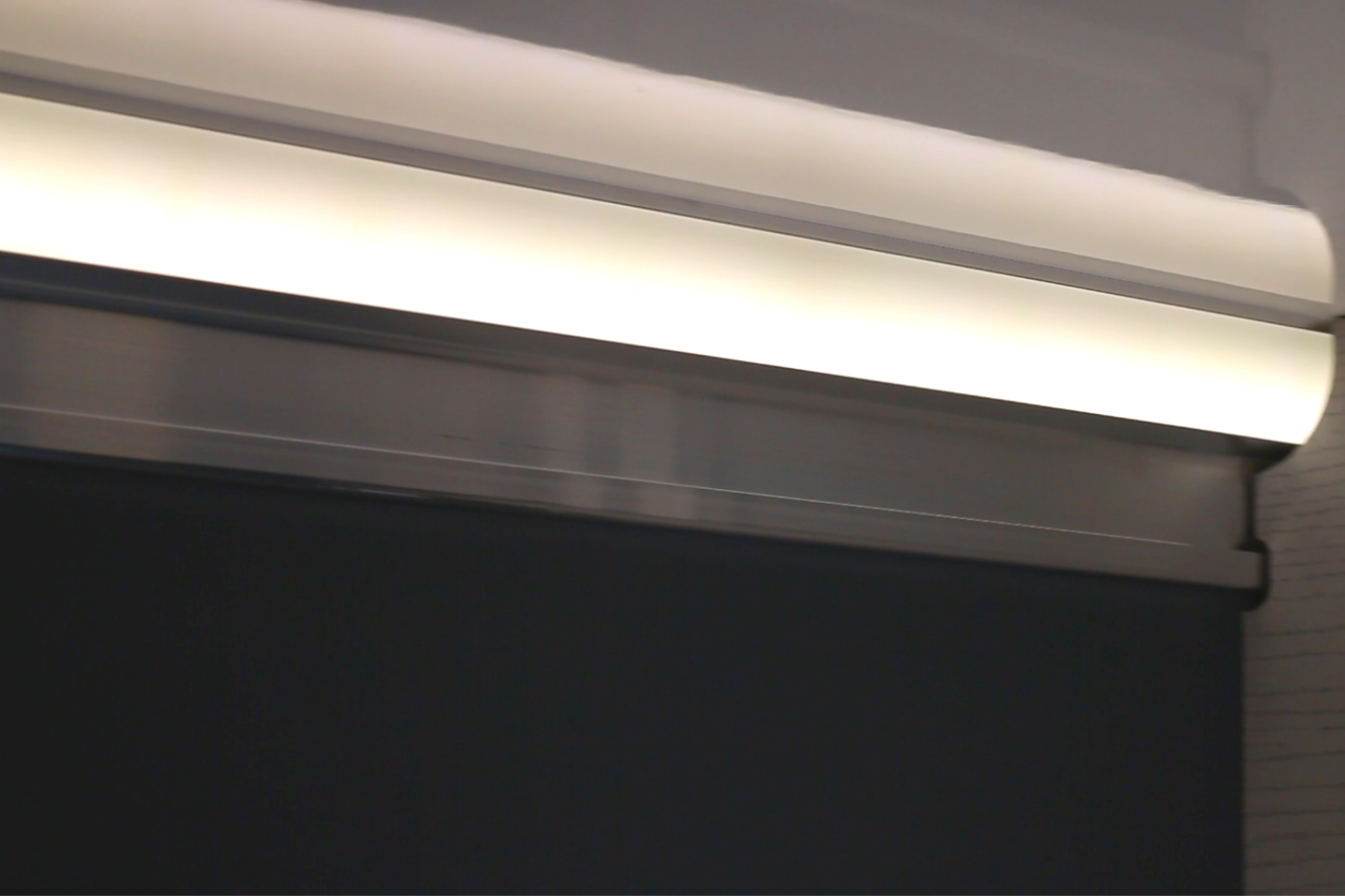 Red CORE ICE trailer set outside on the ice at night behind a four wheeler with tracks on it, a cooler set out front and the LED lights on