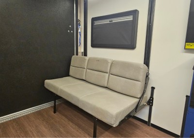 A view of the custom high-quality tan leather on the dinette seat in a CORE RV trailer, shown in the sitting position