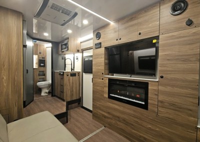Inside view of CORE RV toy haulers entertainment cabinet featuring a sound system, TV and fireplace.
