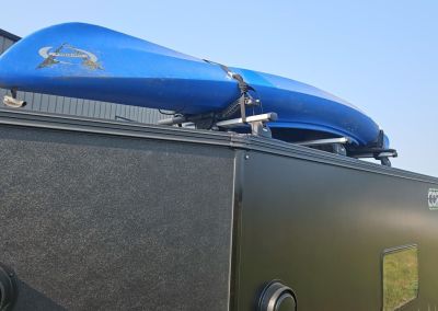 CORE RV 6515 Trailhead rooftop view showing the mounting of a kayak on the rack