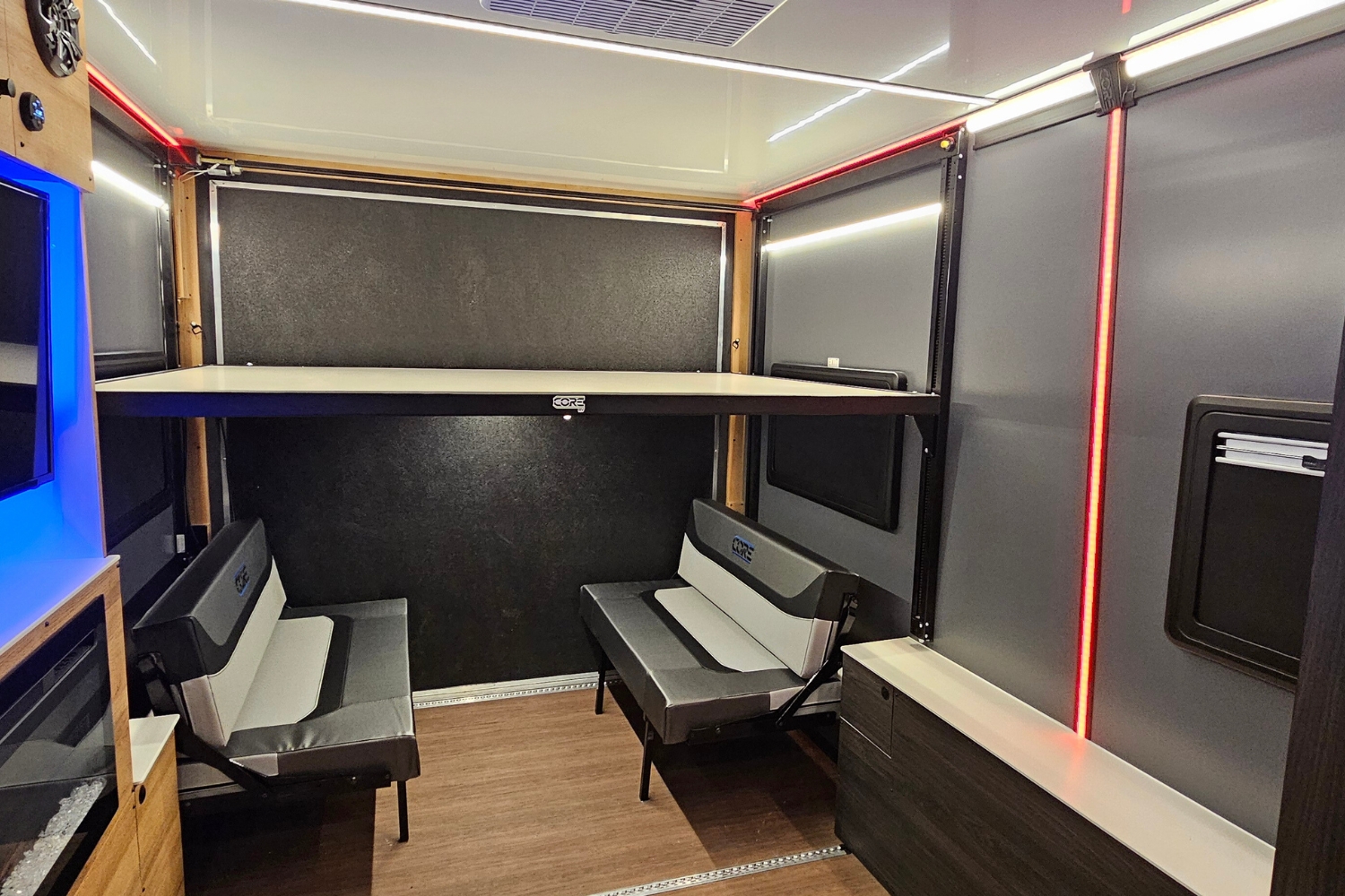 Interior view of a CORE ICE layout with a happijac lift/lower beed and a dinette seating - to illustrate the options for seating and sleeping